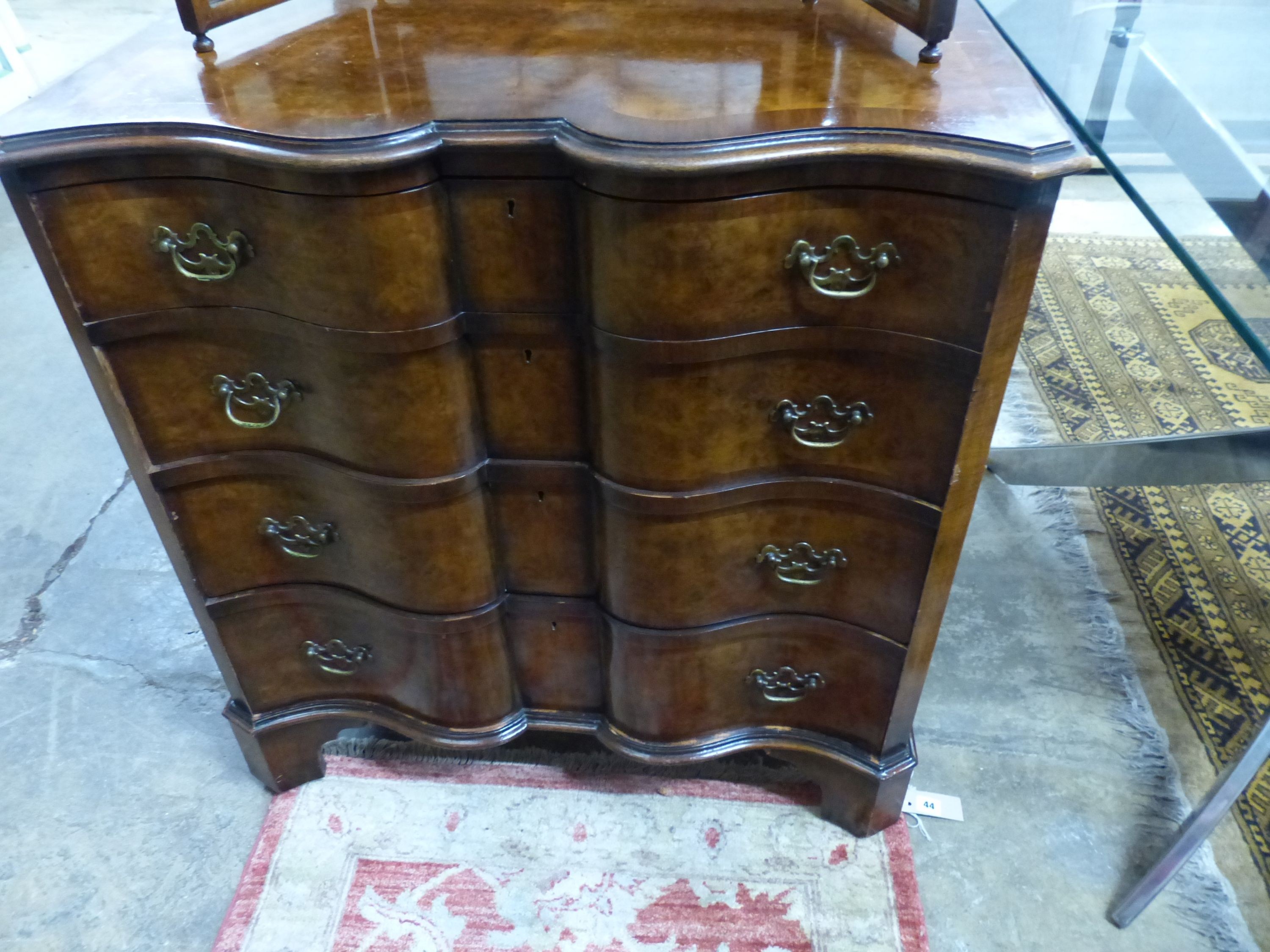 A Queen Anne Revival shaped front walnut chest, W.84cm D.49cm H.88cm, and a walnut triple dressing mirror